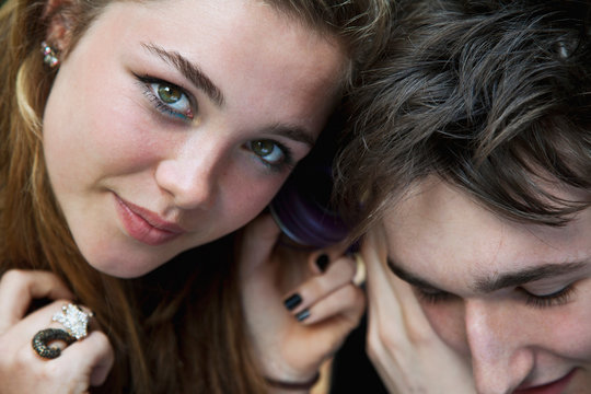 Teenagers listening to headphones
