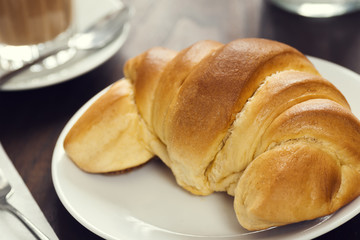 Continental Breakfast in Cafe with Croissant Roll and Coffee