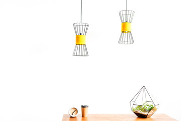 Hot beverage mug with watch and flowerpot on table surface