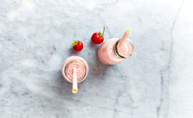 Fototapeta na wymiar Yogurt-Strawberry Smoothie in glass bottles