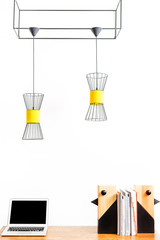 Laptop and statuettes for room setting with papers on desktop