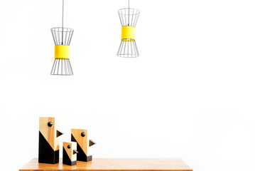 Room setting statuettes on table and ceiling lamps over them