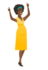 Pregnant woman standing with raised arms up.