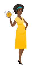 African pregnant woman holding alarm clock.