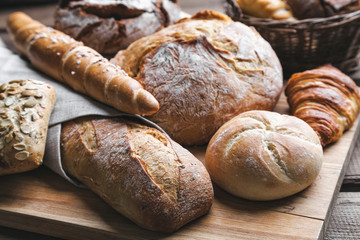 Delicious fresh bread on wooden background