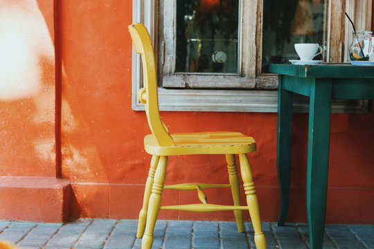 Yellow chair. Tolerance. View of terrace on the street