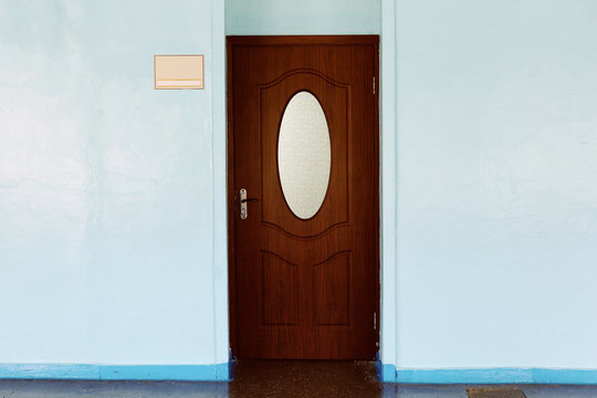Door to the classroom in the school with sign
