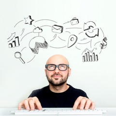 Portrait view of an attractive dubious geek with business icons surrounding his head - Business...