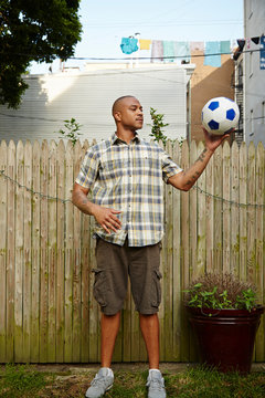 Man holding football in garden