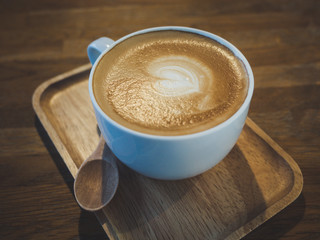 Latte coffee on wooden tray