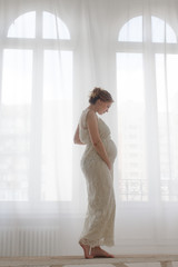 Fototapeta premium Elegant pregnant woman on bench