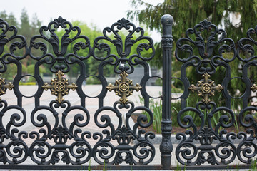 Wrought fence. Image of a decorative cast iron fence. metal fence close up. beautiful fence with artistic forging