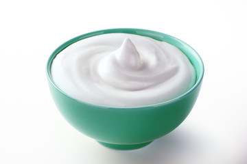 cream sour in wooden spoon