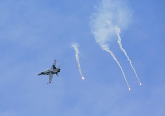 Jet fighter shooting flares.