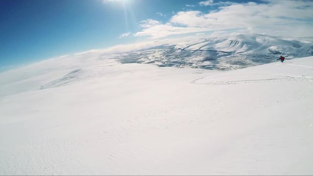 Man skier skiing down mountain with friends - sunny day - first person view