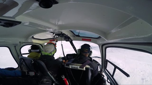 Man skier flies in helicopter as a passenger in winter - first person view