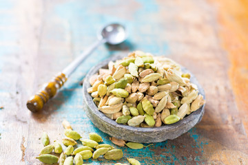 Raw Organic Cardamom Pods on wooden background ready to use