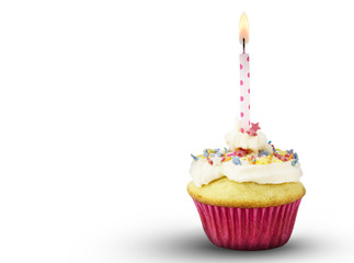Single cup cake with lit pink spotted candle isolated on white background