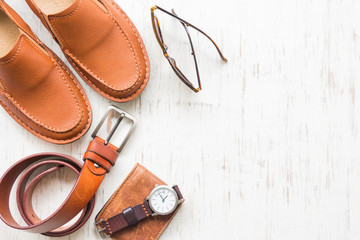 Men's leather accessories on white rustic wooden background