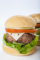 Giant homemade burger classic american cheeseburger isolated on white