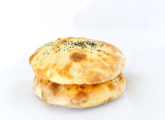 fresh baked bread and flax seeds  on a white background