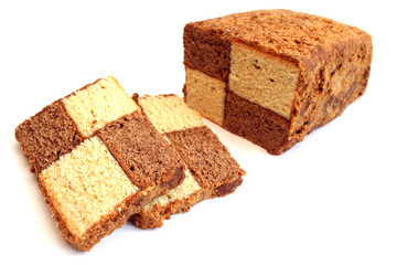 Cupcake made of light and dark dough in the form of a chess cage on a white background.