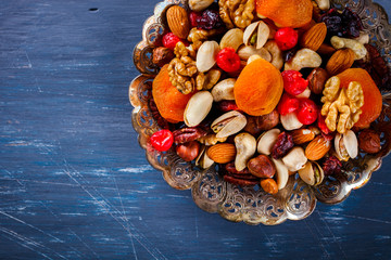 Nuts and dried fruit mix. Concept of Healthy Food. Vintage wooden background. Copy space for Text. selective focus