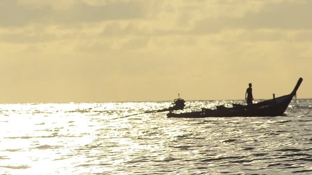 boat fisher man on golden sky background