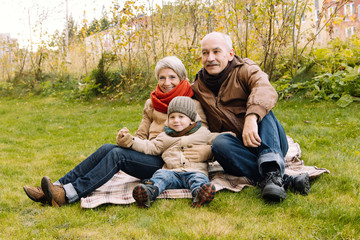 Fototapeta premium Happy family in autumn Park. Family values. The link between generations. 