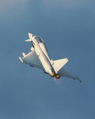 Jet fighter with full throttle and afterburner. Image has a strong vintage effect applied.