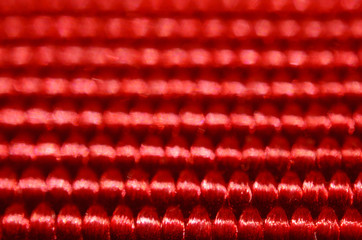 Red nylon belt close-up. Shallow depth of field. The interweaving of the fibers in the belt texture as abstract background