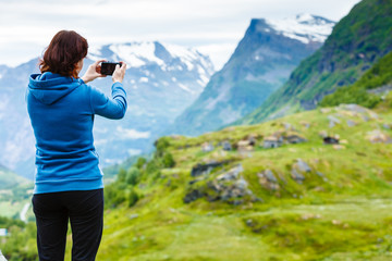 Tourist taking photo in mountains Norway