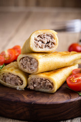 Minced beef stuffed crepes with arugula salad