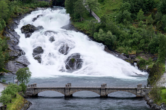 Hellesyltfossen, a waterfall that divides the village of Hellesylt (Norway) into two parts and is ranked as popular tourist attraction.