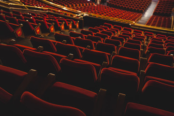 Empty red armchairs of a theater