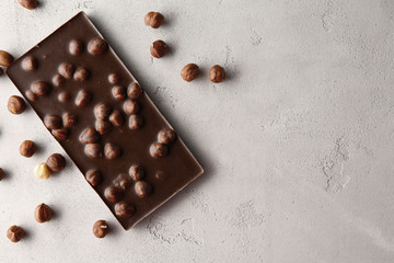 Chocolate bar with nuts on table