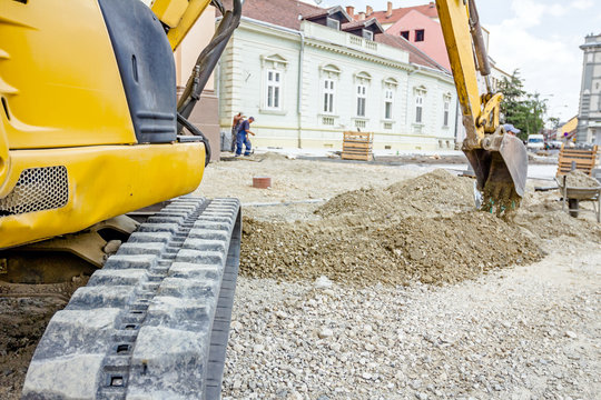 Excavator is digging on building site