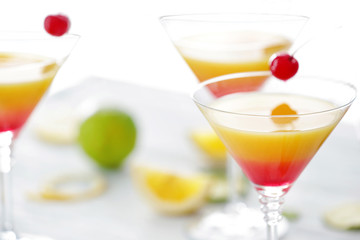 Glass of Tequila Sunrise cocktail on table, closeup