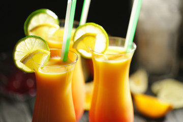 Glasses of Tequila Sunrise cocktail with citrus slices, closeup