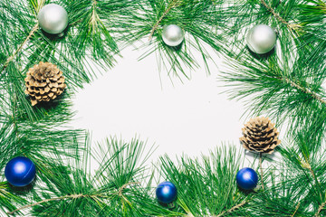 X-mas background with christmas balls, pinecones and green pine leaves. Copy space for text