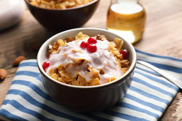 Delicious muesli with berries and yogurt on table