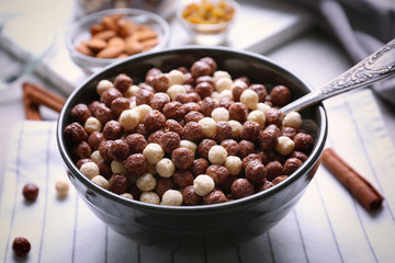 Bowl with delicious cereal balls on table