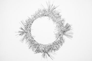 Black and white Christmas background with silver decoration and green pine leaves. Round copy space for text