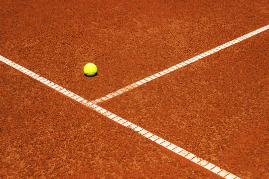 Tennis ball on tennis court. Clay surface.