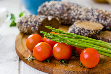 Fresh asparagus, bread and tomatoes