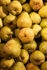 Fresh juicy pears lying on a counter  in the grocery store