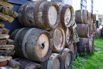 Stacked wooden barrels on backyard