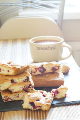 Tea and pie in berries for breakfast, bright lighting from the window, vertical