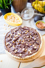 Food, Raw Paleo Chocolate Tart with Nuts and Caramel Sauce, Vertical View