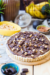 Delicious Vegan Chocolate Cake on White Rustic Wooden Table, Vertical View